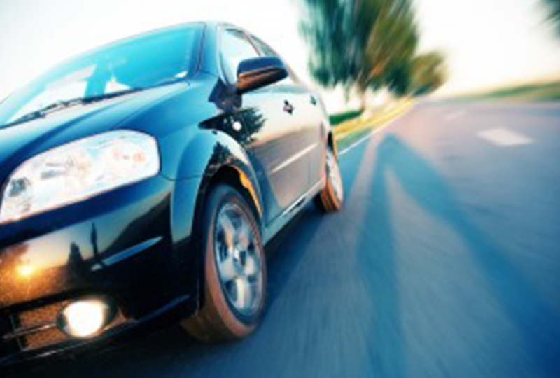 Car Speeding By on Road